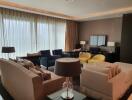 Spacious and elegantly furnished living room with ample seating and natural light