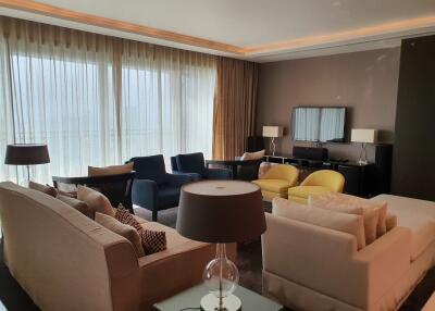 Spacious and elegantly furnished living room with ample seating and natural light