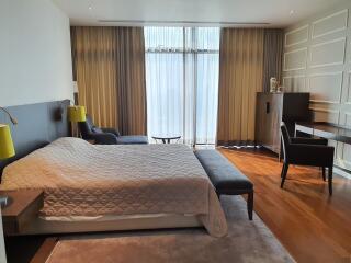 Spacious and elegantly furnished master bedroom with natural light