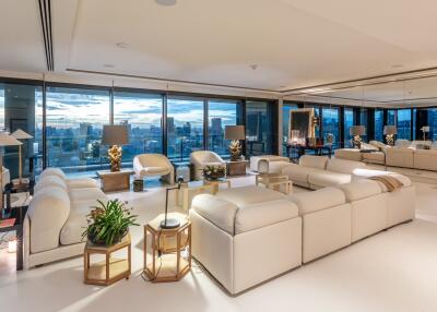Spacious and well-lit living room with city skyline view