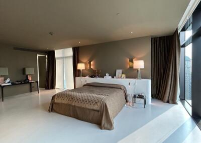Spacious modern bedroom with large windows and stylish decor
