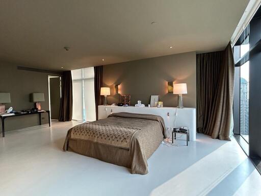 Spacious modern bedroom with large windows and stylish decor