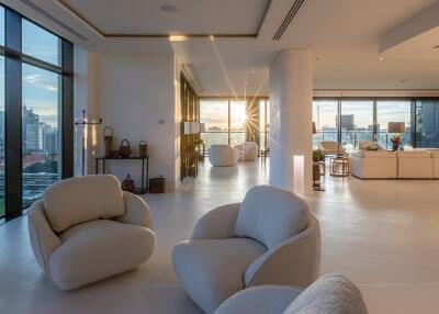 Spacious and modern living room with large windows and cityscape views