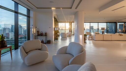 Spacious and modern living room with large windows and cityscape views