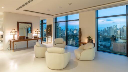 Spacious and modern living room with large windows showcasing cityscape views