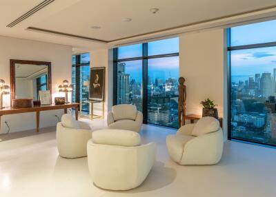 Spacious and modern living room with large windows showcasing cityscape views