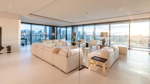 Spacious living room with large windows and city view