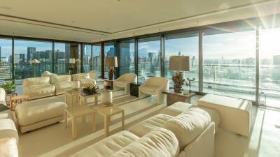 Spacious living room with modern furniture and panoramic city views