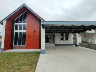 Contemporary house with large windows and a carport