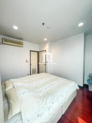 Bright bedroom with large bed and modern amenities