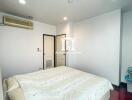 Bright bedroom with large bed and modern amenities