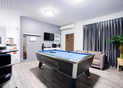 Spacious living room with pool table and modern amenities