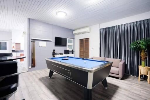 Spacious living room with pool table and modern amenities