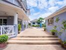 Spacious and welcoming home exterior with clear pathway and tropical plants