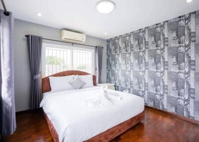 Modern bedroom with stylish decor and hardwood floors