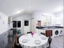 Modern kitchen with integrated dining area and laundry appliances