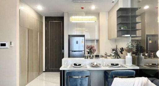 Modern kitchen with integrated dining area featuring stylish decor and lighting