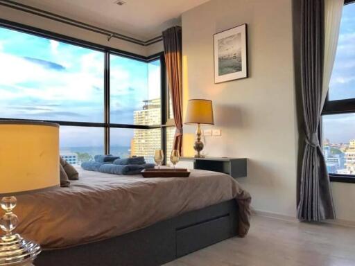 Elegant bedroom with large window and city view
