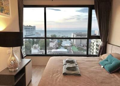 Cozy bedroom with ocean view through large window