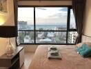 Cozy bedroom with ocean view through large window