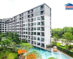 Modern residential apartment building with lush gardens and pool