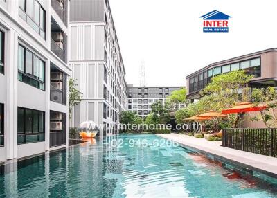 Luxurious outdoor swimming pool surrounded by modern residential buildings