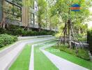 Lush garden area with walking paths in a modern residential complex
