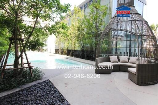 Luxurious outdoor pool area with stylish seating and lush greenery
