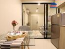 Compact modern studio apartment interior with integrated kitchen, dining, and sleeping area