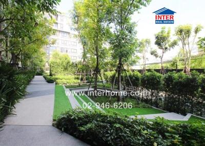 Well-maintained garden pathway in a residential complex with lush greenery