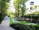 Well-maintained garden pathway in a residential complex with lush greenery