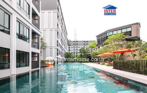 Luxurious pool with modern buildings in the background