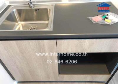 Modern kitchen sink and countertop with wooden cabinets