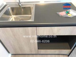 Modern kitchen sink and countertop with wooden cabinets