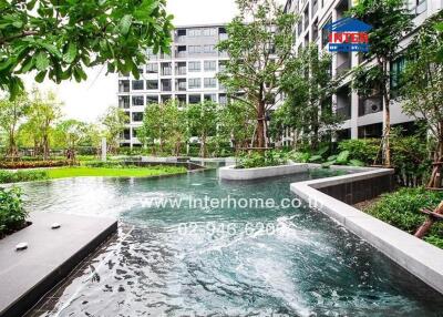 Luxurious residential building with lush gardens and water features