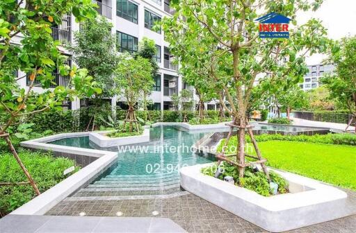 Lush communal garden with swimming pool in modern residential building