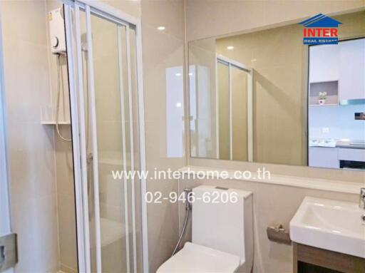 Modern bathroom with glass shower and large mirror