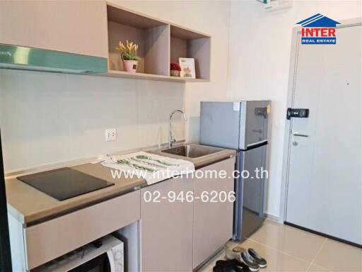 Modern compact kitchen with built-in appliances and ample storage