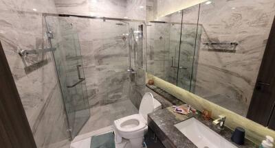 Modern bathroom with glass shower and marble tiles