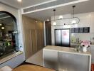 Modern kitchen with stainless steel island and pendant lighting