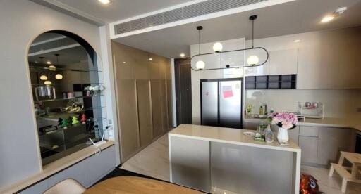 Modern kitchen with stainless steel island and pendant lighting