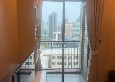 Modern bedroom with large window view of city