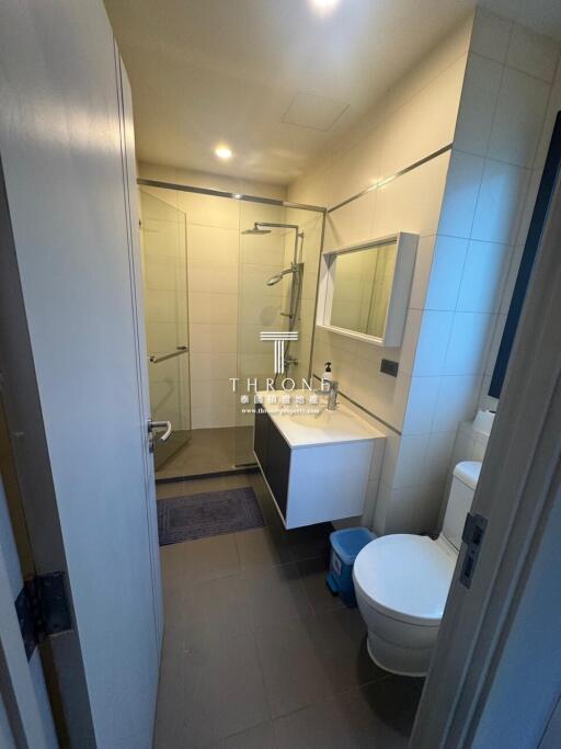 Modern bathroom with glass shower and white fixtures