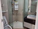 Modern bathroom interior with glass shower enclosure and vanity