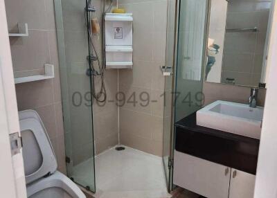 Modern bathroom interior with glass shower enclosure and vanity