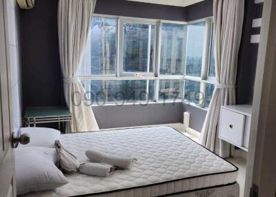 Spacious bedroom with large windows and modern furnishings