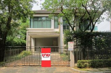 Front view of a modern two-story house with gated entrance