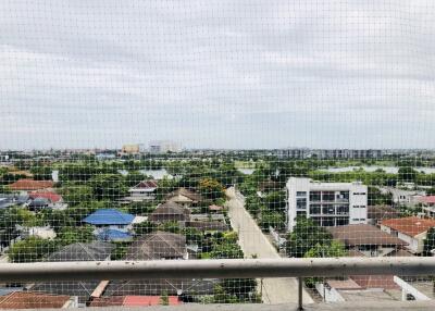 Panoramic view from a high-rise building balcony overlooking a lush suburban area