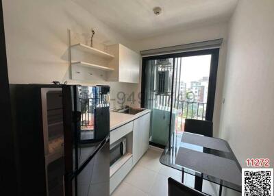 Modern apartment kitchen with dining area and balcony access