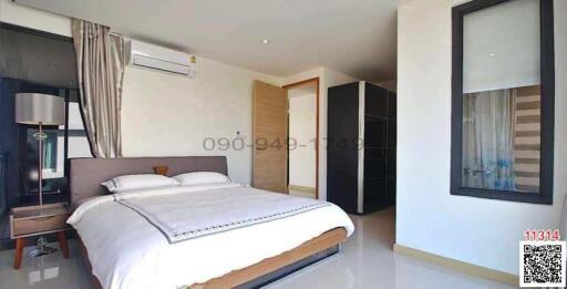 Modern bedroom with a large bed and natural light